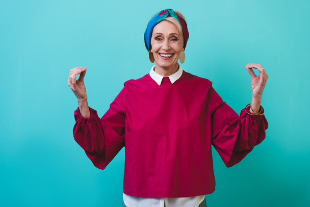 happy senior woman spirituality gesturing isolated on blue - Photo, Image