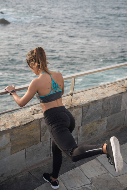 young woman exercising by seaside - Foto, Imagen