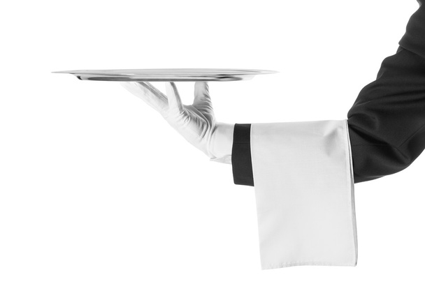 A hand holding a silver tray - Фото, зображення