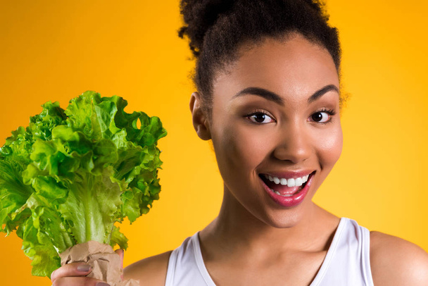 African American girl holding salad isolated. - Photo, image