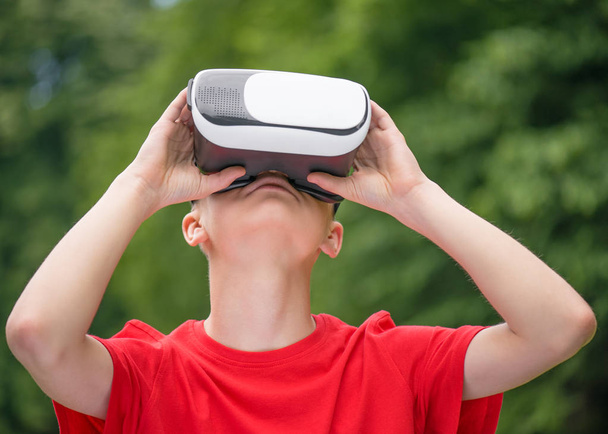 Teen boy with VR glasses - Фото, изображение