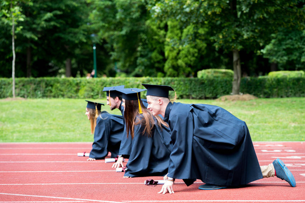 Graduation group of students celebrating on athletic track, prep - Photo, Image