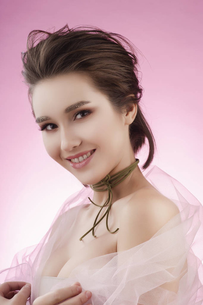 Closeup portrait of a beautiful smiling asian girl wearing pink  - Фото, зображення