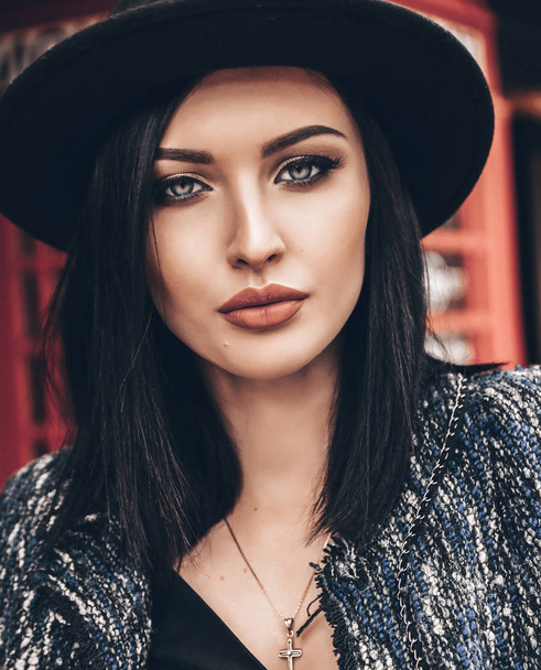 pretty woman with short dark hair in elegant outfit and black ha - Fotografie, Obrázek