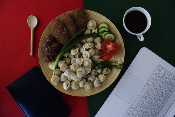 top view of  home made dumplings, chops, coffee cup, notepad  and laptop   - Photo, Image