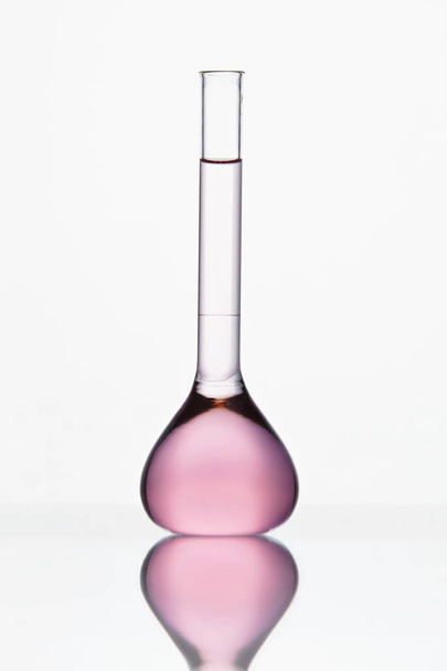 Laboratory Glassware. Glass With Pink Liquid On White Background - 写真・画像