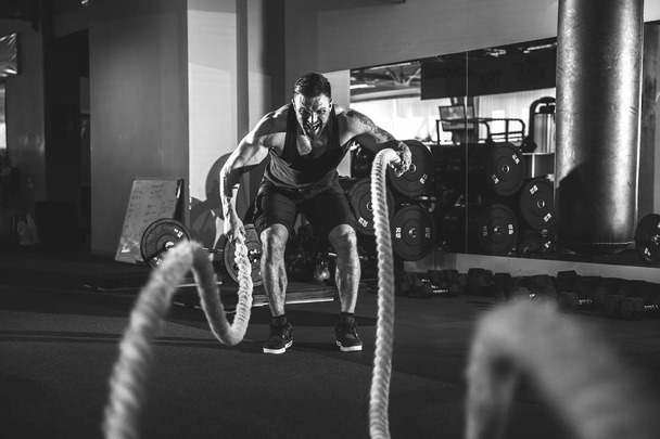 Men with rope in functional training gym - Photo, Image