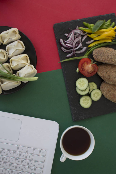 zelfgemaakte dumplings, laptop, koffiebeker op tafel  - Foto, afbeelding