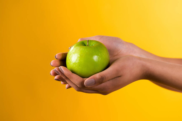 Close up black girl holding apple isolated. - Photo, Image