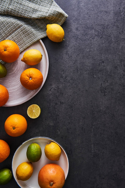 Fresh ripe citruses on dark background - Photo, image