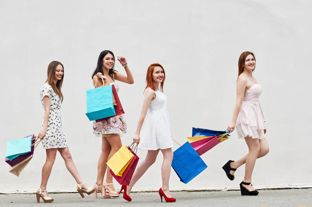 four slim Women friends with Shopping Bags - Фото, изображение