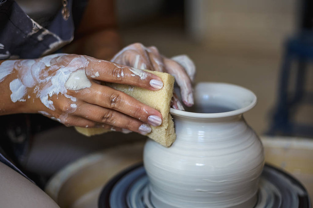 Potter making ceramic pot or vase on pottery wheel - Photo, Image