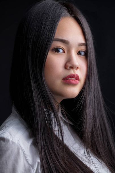 Asian young woman in white over black background. Black and Whit - Photo, image