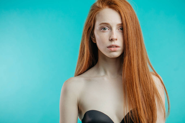 Female model with red loose hair and natural make-up posing over - Foto, Bild