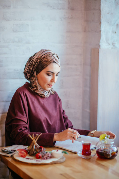muslim woman working in cafe - Photo, Image