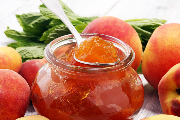 Peach vanilla jam with fresh peaches on table. - Photo, Image