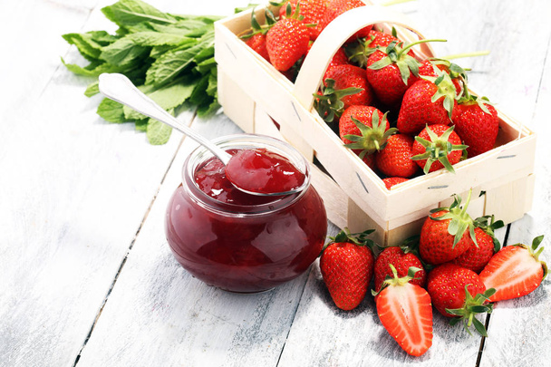 Strawberry jam in a jar and fresah strawberries. - Photo, Image