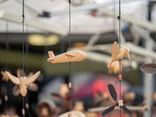 Wooden Japanese ornaments hanging at an outdoor market - Photo, Image