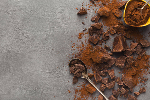 Crushed chocolate pieces on gray background, top view - Foto, imagen