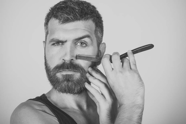 Serious hipster in barbershop, new technology - Fotoğraf, Görsel
