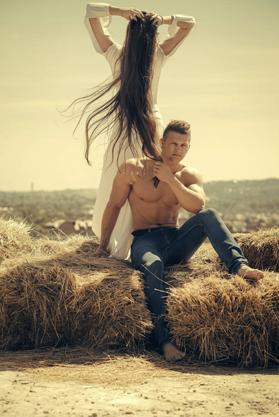 Couple in love on hay on mountain landscape - Foto, immagini
