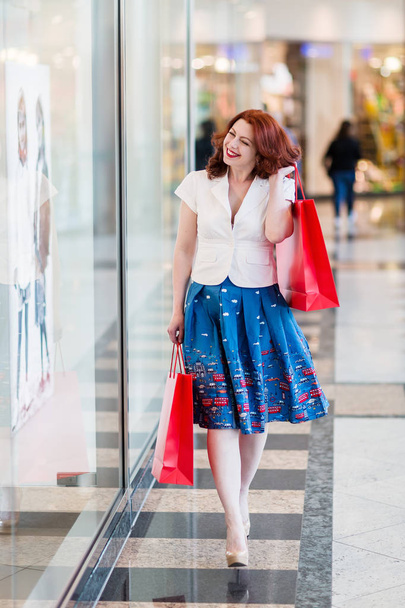 woman with shopping bags in a mall - Photo, Image