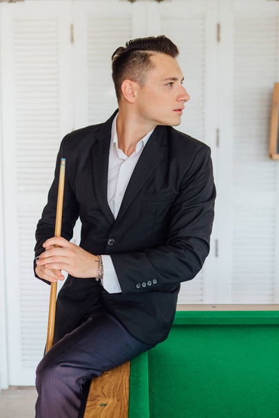 Young handsome man playing billiard game alone - Фото, изображение