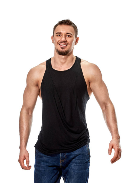 Muscular smiling young man posing - Foto, imagen