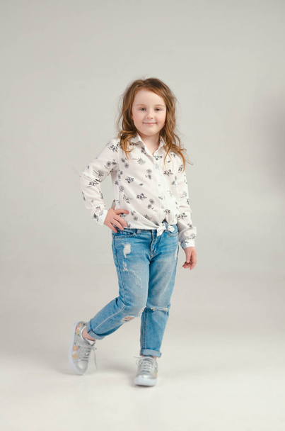 child in the Studio posing in fashionable clothes - Valokuva, kuva