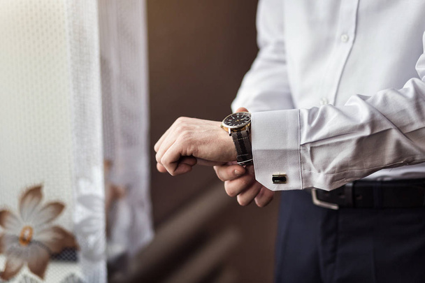 businessman checking time on his wrist watch, man putting clock on hand,groom getting ready in the morning before wedding ceremony - Photo, image
