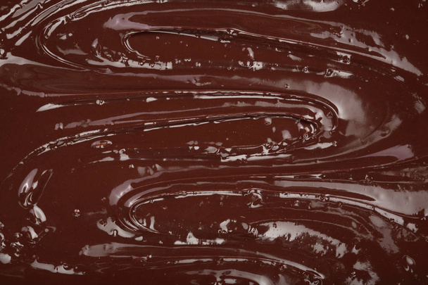 Melted chocolate swirl as a background closeup - Zdjęcie, obraz