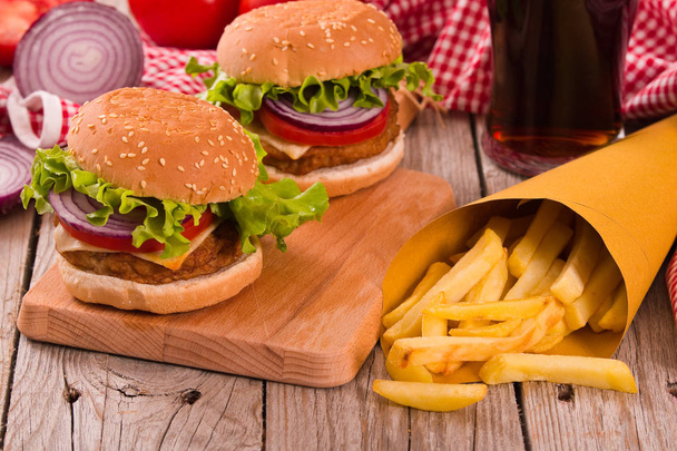Hamburgers with french fries on wooden table. - Photo, Image