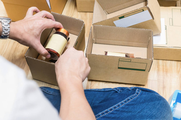 Employees are packing a parcel in the send to the customer. Online ordering For the convenience of customers. - Photo, image