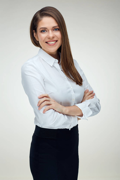 Confident smiling businesswoman woman wearing white shirt standing with crossed arms  - Фото, изображение