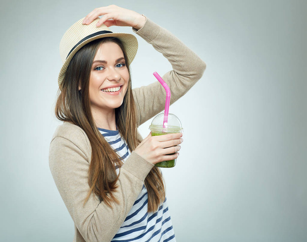 smiling woman in casual style clothes holding detox cocktail with straw - Photo, image