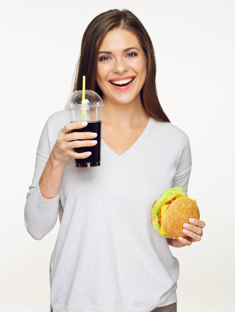 woman holding burger with cola drink isolated on white background, close-up  - Foto, Imagen