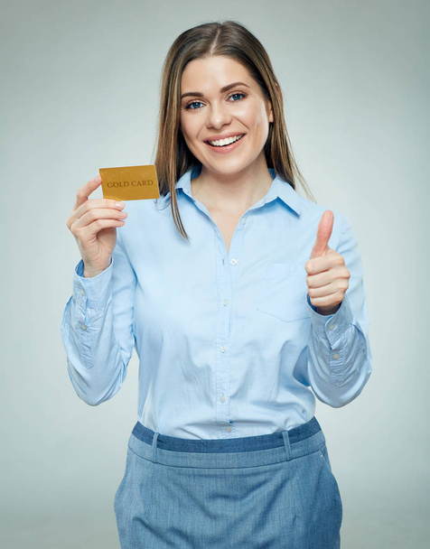 Happy woman holding credit card and showing thumb up - Valokuva, kuva