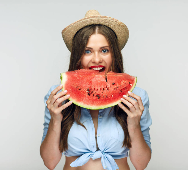 beautiful woman in mexican hat eating watermelon - Photo, Image