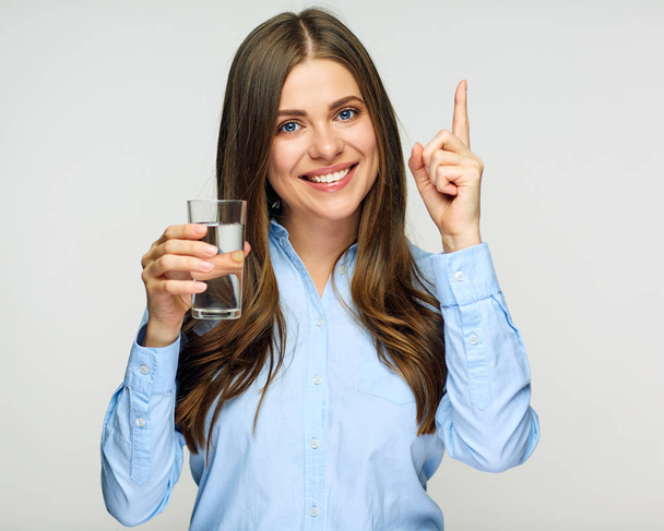 Business woman holding water glass and pointing finger up - Fotografie, Obrázek