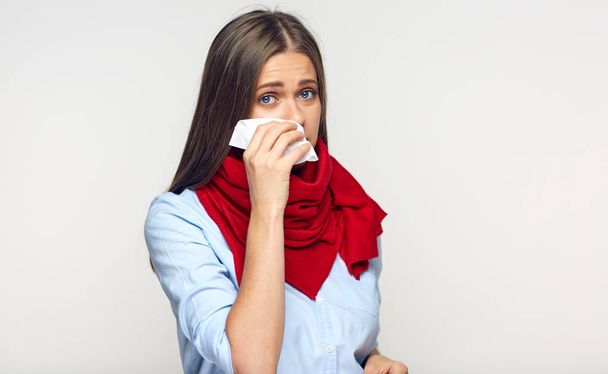 Sickness woman blowing nose in paper tissue on light background - Foto, Bild