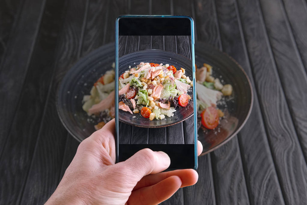 Photographing salad with smoked salmon with mobile phone. Food blogging - Fotoğraf, Görsel