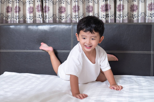 3 years old little cute Asian boy at home on the bed, kid lying  - Zdjęcie, obraz