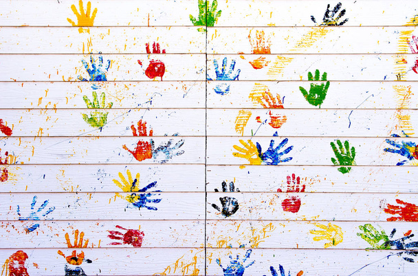 Красочные ручные печати на белой деревянной стене для использования в качестве фона
  - Фото, изображение