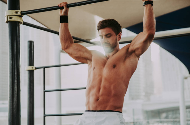 Beautiful man doing work out and different exercises outdoor  - Photo, Image