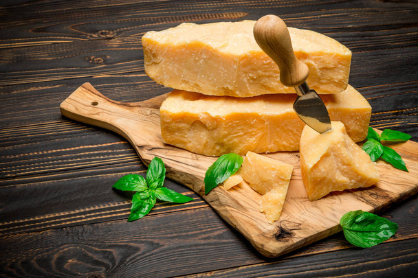 pieces of parmesan or parmigiano cheese and grapes - 写真・画像