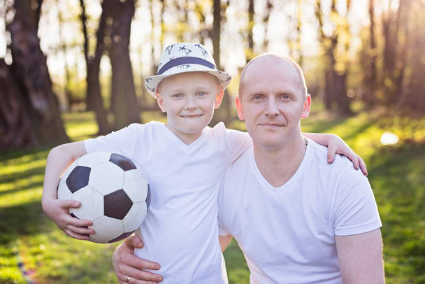 Happy father and son portrait in park - Photo, image