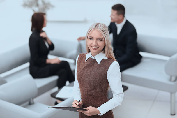 young woman assistant standing in the lobby of the modern office . - Foto, Imagen