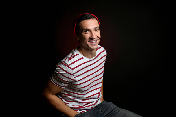 smiling young man in casual clothes on black background - Fotoğraf, Görsel