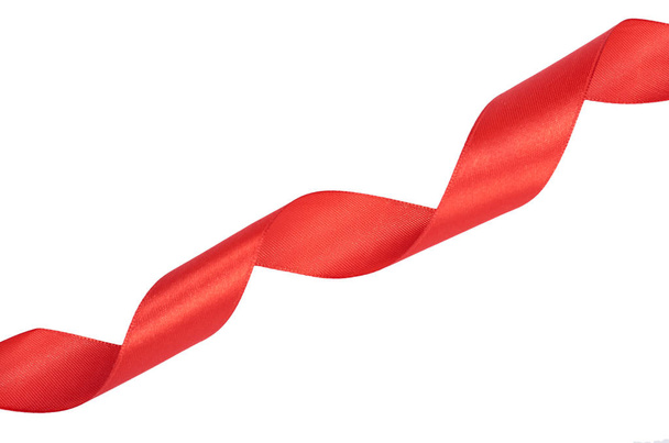 Red silk swirled ribbon. Isolated on white background. Copy space - Zdjęcie, obraz
