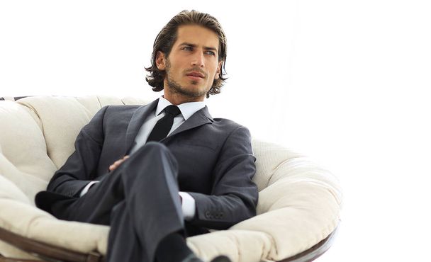 confident businessman sitting in a large comfortable chair. - Foto, Imagen
